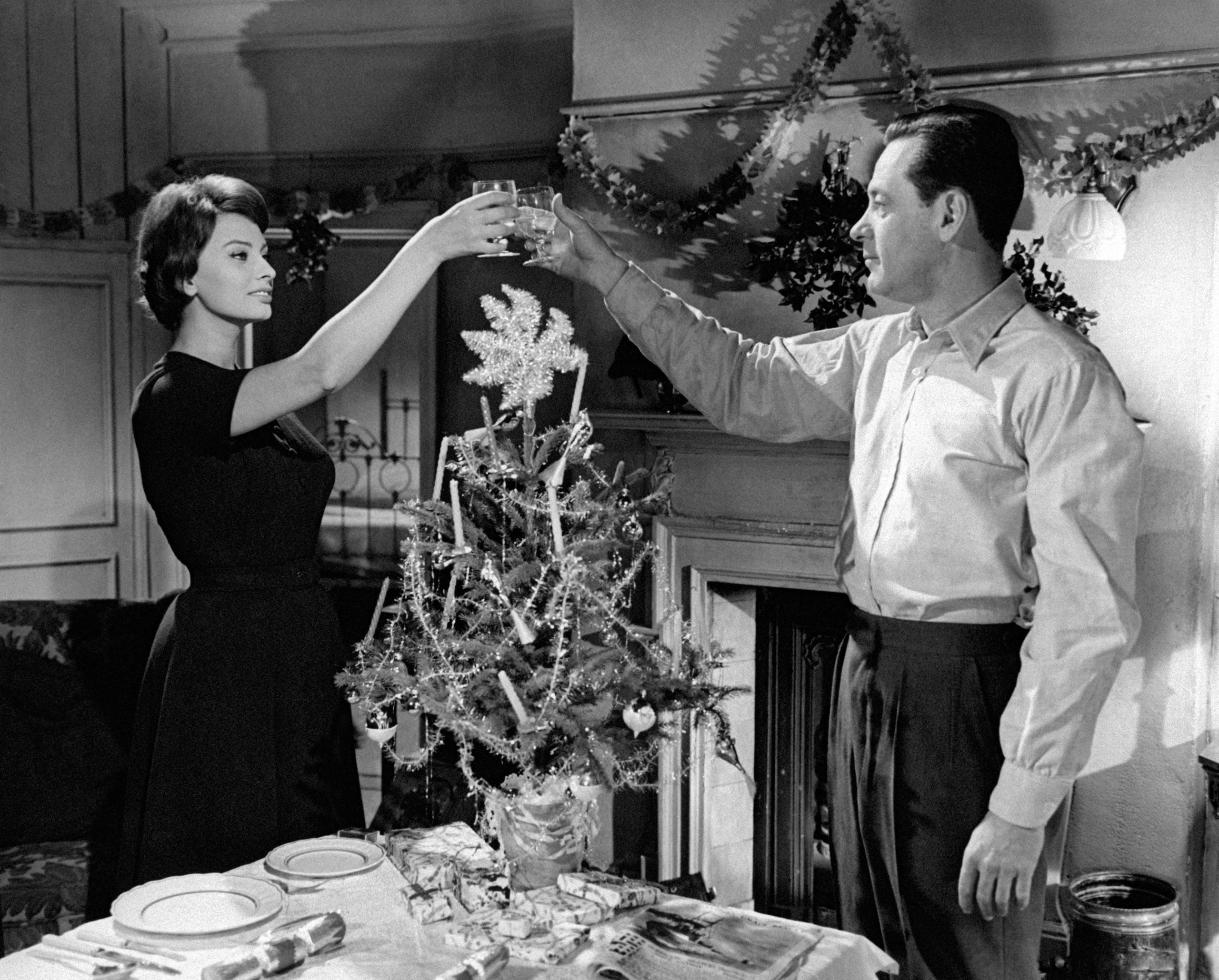 Vintage photo of Sophia Loren and WilliamHolden Toasting drinks.